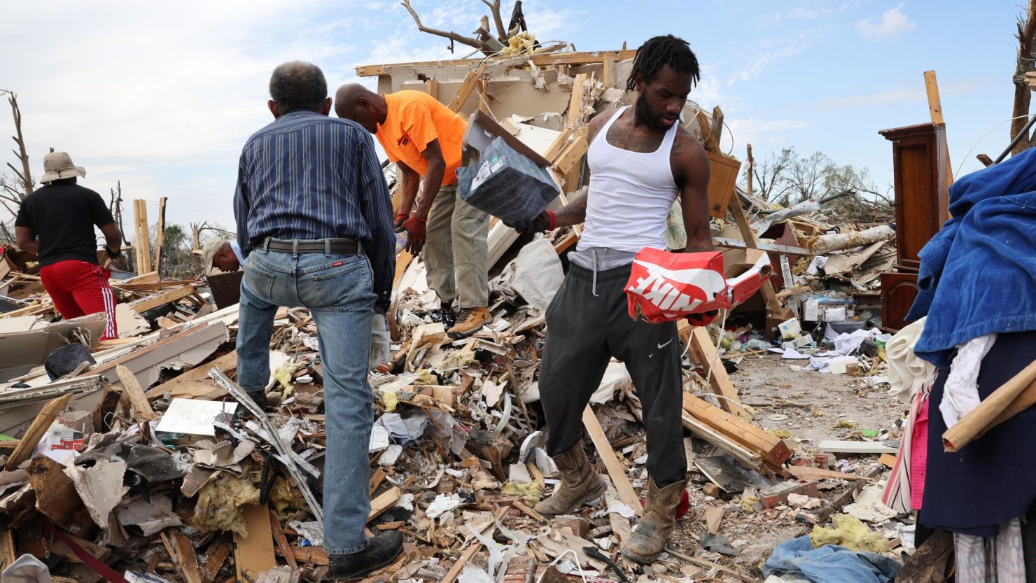 Volunteers and community members working together to recover belongings and rebuild after disaster