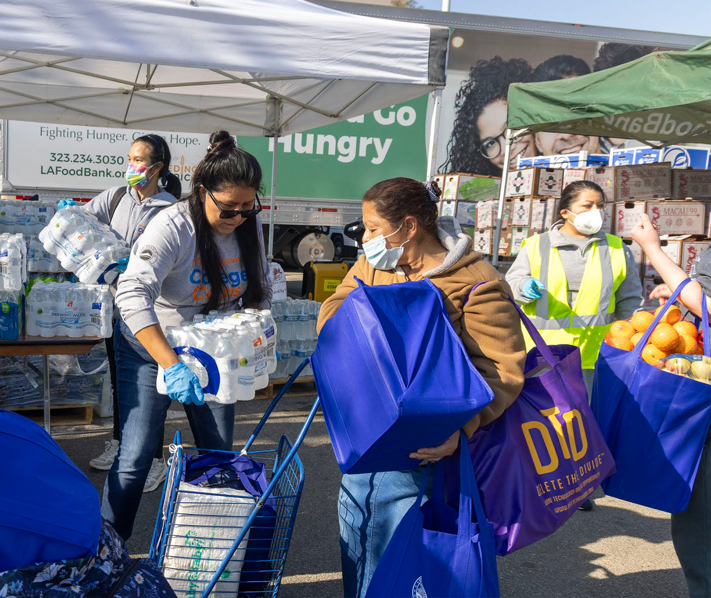 Volunteers distributing emergency supplies including water and food to families affected by disaster