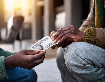 Hands exchanging money representing immediate financial assistance during emergencies