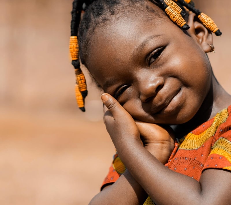 Young girl smiling - Empowering Lives Through Compassion